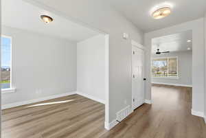 Empty room with light wood-style flooring and a ceiling fan