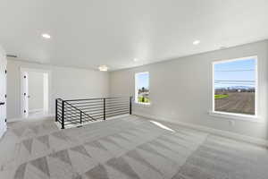 Spare room with light colored carpet and recessed lighting