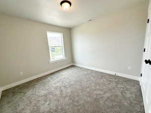 Spare room with light colored carpet and baseboards
