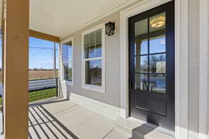 View of exterior entry with a porch