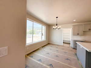 Unfurnished dining area featuring a chandelier, recessed lighting, and a textured ceiling