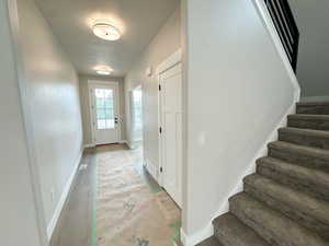 Doorway featuring baseboards and stairs