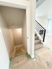 Staircase with recessed lighting and baseboards