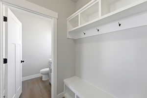 Mudroom with light wood finished floors and baseboards