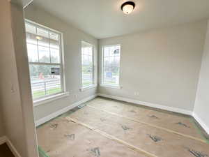 Unfurnished room featuring baseboards