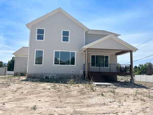 View of front facade with a porch, stairway, and roof with shingles