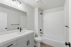 Full bath with vanity, shower / washtub combination, and light wood-style floors