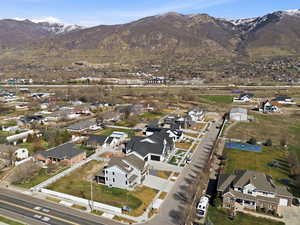 Aerial view of property's location with nearby suburban area and a mountainous background