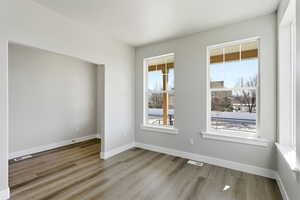 Empty room featuring light wood-style flooring and baseboards