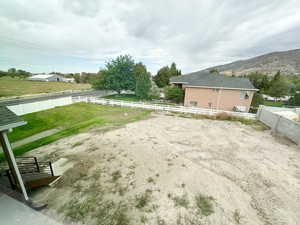 Fenced backyard with a mountain view