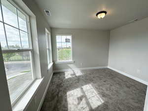 Empty room featuring carpet floors and baseboards
