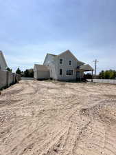 Rear view of property featuring a storage shed
