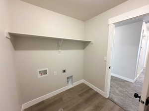 Washroom featuring washer hookup, electric dryer hookup, and dark wood finished floors