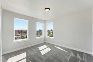 Carpeted spare room with plenty of natural light