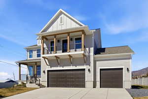 View of front facade featuring a porch, concrete driveway, board and batten siding, a garage, and a shingled roof