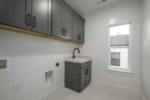 Laundry room with washer hookup, cabinets, sink, and hookup for an electric dryer