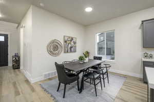 Dining area with light wood-type flooring