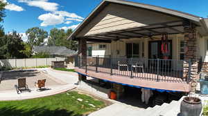 Rear view of house with ceiling fan and a patio area