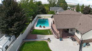 View of swimming pool with a patio and a lawn