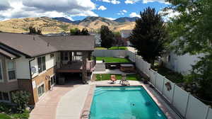 View of swimming pool featuring a patio, central AC unit, and a mountain view