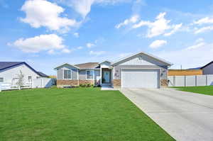 View of front of house with a front lawn and a garage