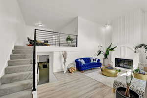 Living room featuring wood-style flooring and a fireplace