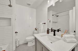 Full bathroom with tile patterned floors, a textured ceiling, vanity, toilet, and shower / bathtub combination with curtain