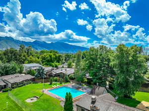 View of swimming pool featuring a yard and a mountain view