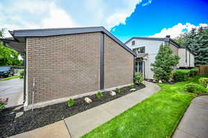 View of property exterior, walkway leading to private front porch