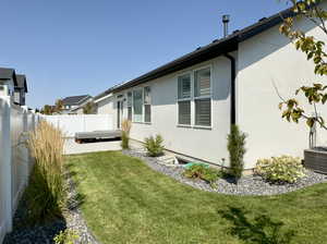 Exterior space featuring central air condition unit, a patio area, and a yard