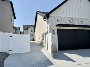 View of side of property with a garage