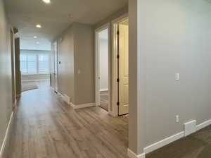 Hall with light hardwood / wood-style flooring