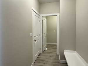 Hallway with light hardwood / wood-style floors