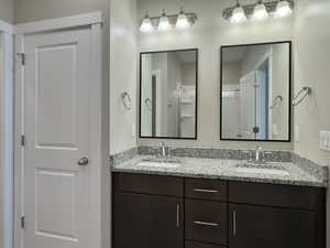 Bathroom featuring vanity and a shower with shower door