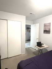 Bedroom featuring a closet and carpet flooring