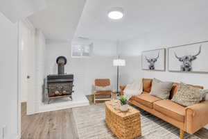 Living room featuring wood-style flooring and a wood stove