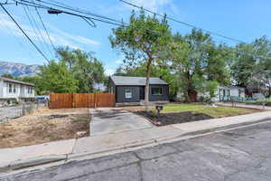 View of front of house with a mountain view and long driveway