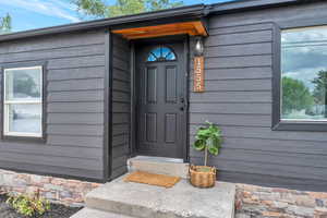 View of exterior entry with wood accents