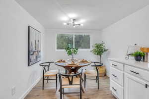 Dining space featuring light wood-type flooring and modern lighting