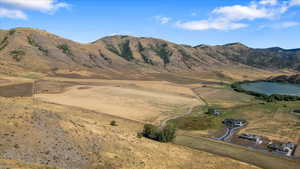 Property view of mountains featuring a rural view and a water view