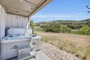 Walk-out patio from lower level.  Hot tub, with mood setting cafe lights