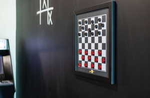 Game room with chalkboard wall and magnetic checkers game on wall