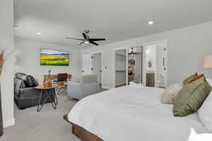 Primary Bedroom with sitting area, desk, and 65" TV