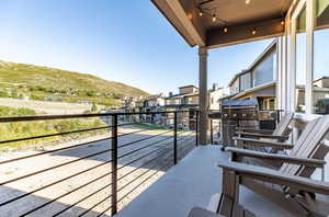 View from main floor balcony with 3 Adirondack chairs and BBQ grill