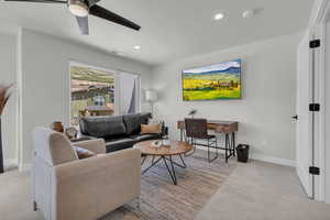 Primary Bedroom with sitting area, desk, and 65" TV