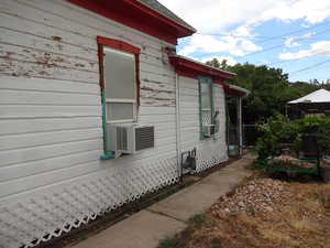 View of side of property with cooling unit