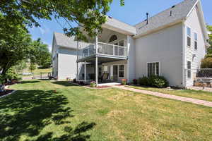 Rear view of house featuring a patio area, a balcony