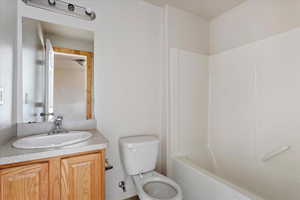 Full bathroom featuring bathtub / shower combination, vanity, and toilet