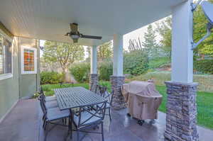 View of patio featuring ceiling fan and grilling area with TV for viewing and entertainment