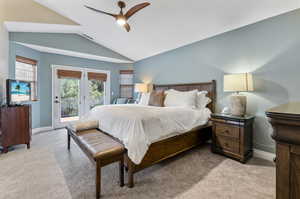 Primary Bedroom with Private Deck to Sunrise Views.  Carpeted bedroom with ceiling fan, access to outside, french doors, and lofted ceiling